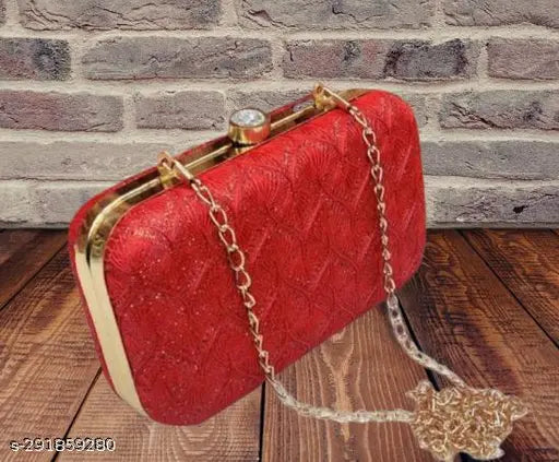 The image displays a red box clutch with a chain sling, fashionable and trendy accessory for bridesmaids, suitable for bridal party events or weddings