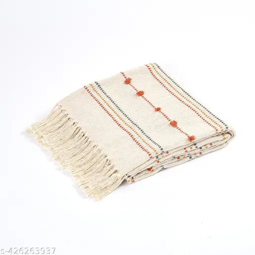 A large, rectangular home decor piece with fringe ends