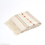 A large, rectangular home decor piece with fringe ends