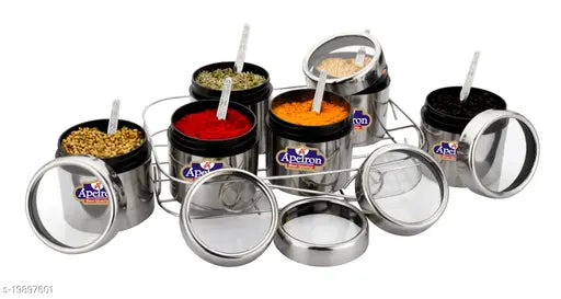 A set of six spice containers with lids, filled with different colored spices in a white display case