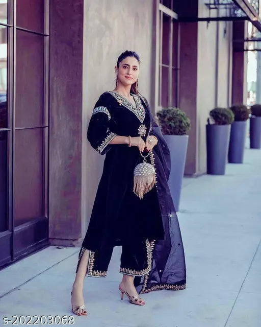 Black velvet outfit with embroidered sequin details and bell sleeve design