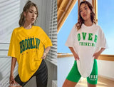 Female model showcasing oversized tshirt combo in Brooklyn style, sporting colors yellow and blue, with one featuring overthinking text