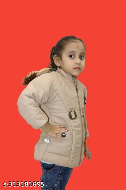 Baby girl in beige jacket posing against red background