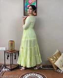 Light green cotton Anarkali gown with flared silhouette and mirror work embroidery, suitable for women's parties or special occasions. Sizes available: S-7XL
