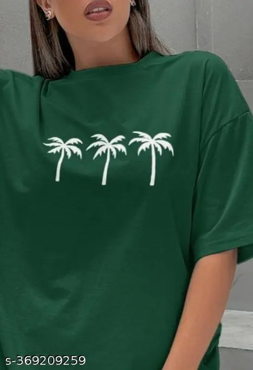 A woman wearing a green T-shirt with the palm trees logo, standing indoors