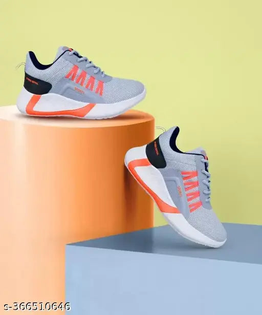Grey sport shoes with orange accents and black soles