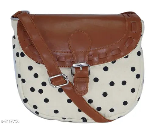 Brown leather crossbody slingbag with polka dot pattern, adjustable strap