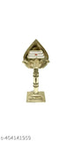 A gold metal Om with a glass top, placed on a temple or car dashboard