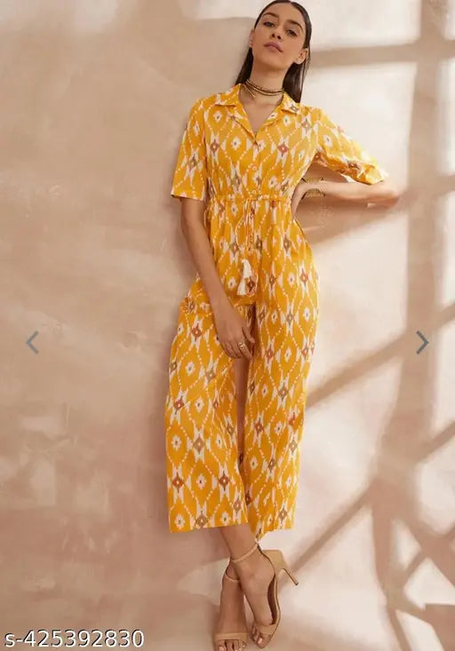 Yellow rayon jumpsuit, printed net design, short sleeves, size XS (34-32-36). Model wears the XS size