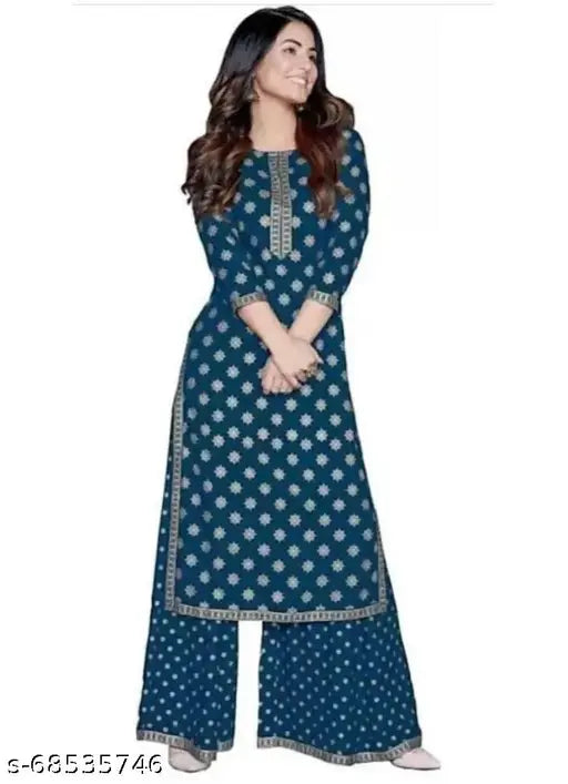 A woman in a blue rayon kameez with long pants, standing against a white background