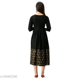Black long kurti with gold print detailing a person standing on the right