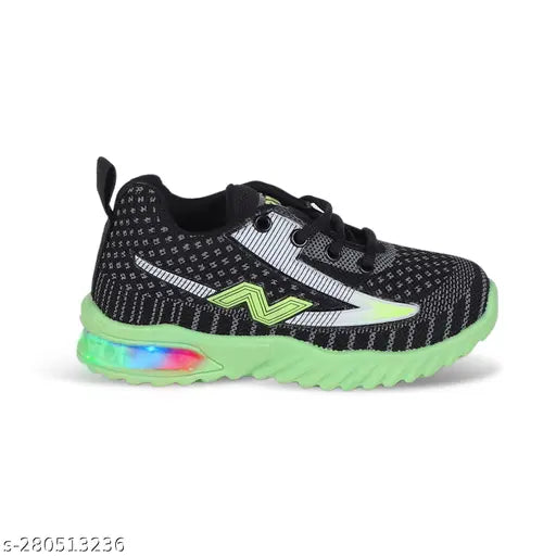Black, white, and green New Balance kids sneakers with reflective LED light