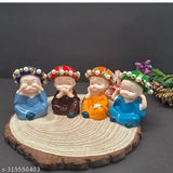 Multi-colored polyresin baby monk Buddha idols (4 pcs), handcrafted Indian decor for home, office & car