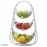 A stainless steel 3 tier fruit storage basket with a variety of colorful fruits