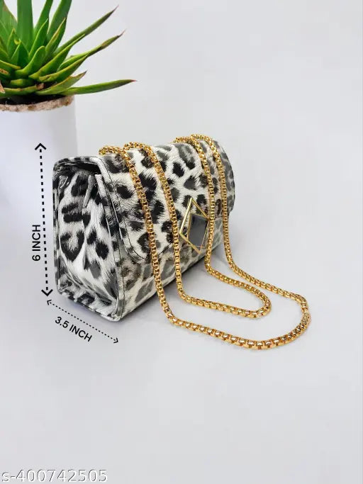 Black leather sling bag with multiple chain straps, featuring a small clutch purse with gold chains
