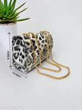 Black leather sling bag with multiple chain straps, featuring a small clutch purse with gold chains