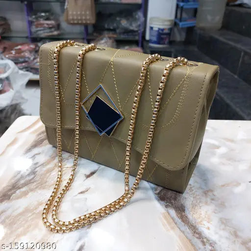 Gold metallic sling bag with a blue logo on it