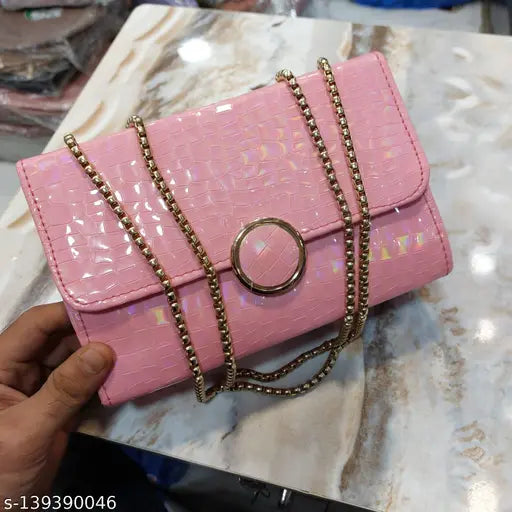 Pink faux leather clutch purse with gold chain accents, featuring multiple pockets and a circular metal hardware detail