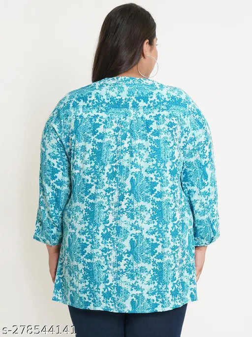 Turquoise blue and white abstract printed viscose rayon plus size top with mandarin collar, three-quarter sleeves, side slit, and button closure. Indian women's fashion." (124 characters)