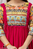 Colorful embroidered kameez with red border, long sleeves, fitted waist