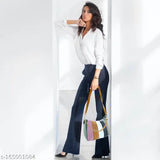 Woman in sleek high heels holding a sling bag with various colors, possibly faux leather or satin fabric, against a neutral background