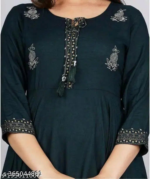 Mid-length blue tunic with green embroidered borders and a front button closure