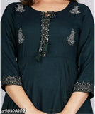 Mid-length blue tunic with green embroidered borders and a front button closure