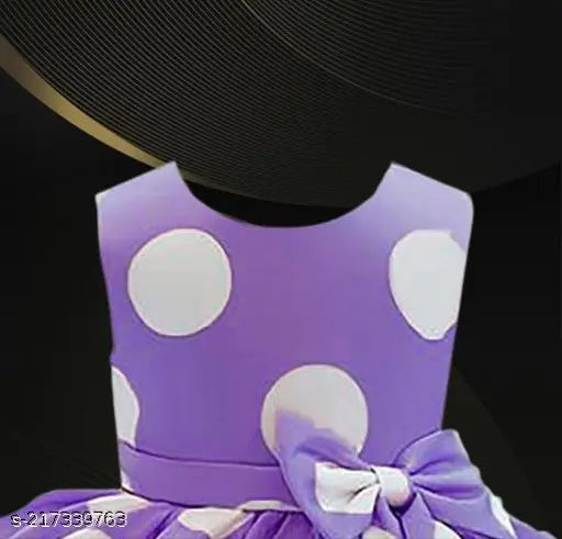 Purple dress with white polka dots, purple bow at neck, and matching pink scarf