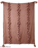 A pink soft plush throw rug, featuring a chain tuft pattern and tassels on all corners