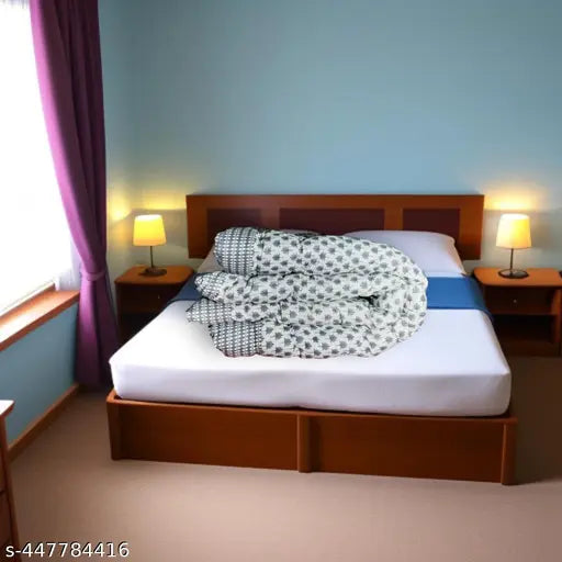 Gray microfiber comforter with a quilted design on top of a bed in a room