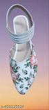 Colorful fabric with white roses and leaves, flat shoes or flats