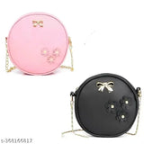 Womens pink and black crossbody handbag with metal accents and shoulder strap