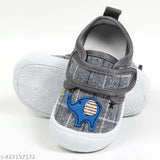 Grey Velcro casual shoes with anti-skid sole, featuring a musical chu-chu sound. Suitable for babies from 3 months up to 25 years old, these slip-on kids' shoes are unisex and come in a grey color. The shoes have an adjustable velcro closure and a non-slip sole with the chu-chu sound, making them perfect for young children learning to walk