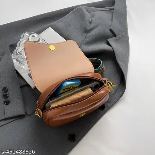 A tan mini crossbody bag, trendy, under $300, with a visible phone pocket and adjustable strap