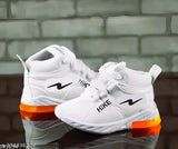 White sneakers with orange accents, lace-up design