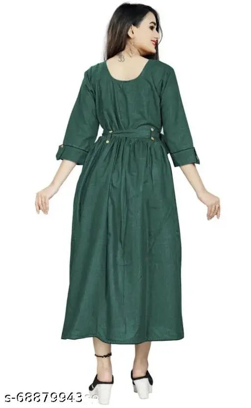 A woman wearing a green kameez dress with shoulder ruffles and side pockets