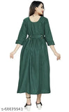 A woman wearing a green kameez dress with shoulder ruffles and side pockets