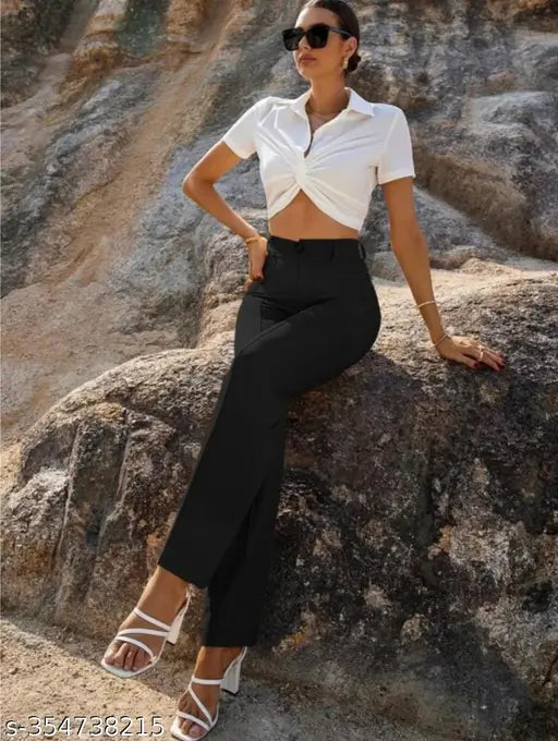 Black trouser with bell bottom style, worn by woman posing in front of mountain