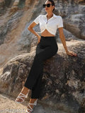 Black trouser with bell bottom style, worn by woman posing in front of mountain