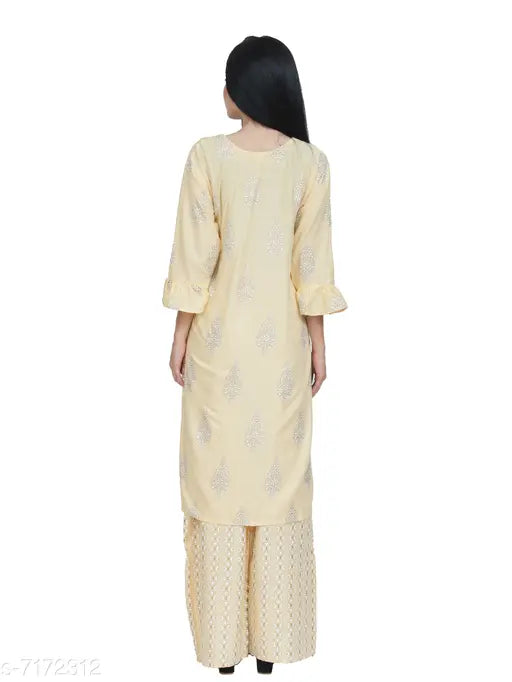 Yellow rayon kurta set with palazzo bottoms, featuring printed net design and three-quarter sleeves. Women's fashion from India