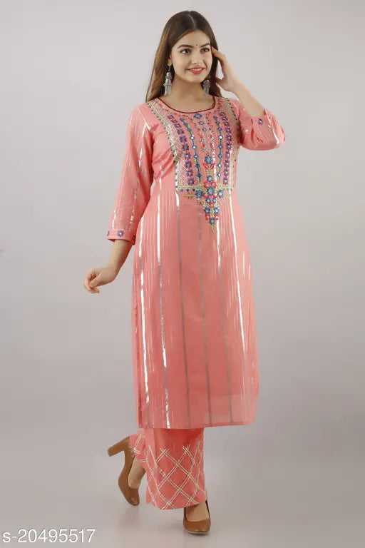 A woman in a pink, cotton blend kurta and pant set
