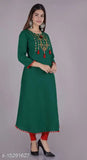 Adrika Sensational long green kameez with red pants and jewelry