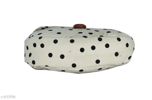This is a single-line description of the image: "Black polka dot slingbag with adjustable strap, suitable for women's casual outings