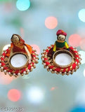 Tealight candle in red and gold candle holder, featuring a puppet design and a round opening