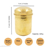A brass canister with a lid, small in size, displayed against a scale