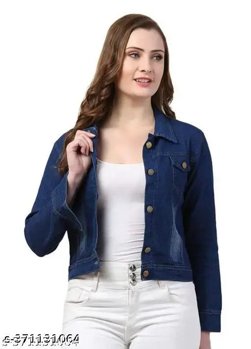 Girl in white shirt, standing with hands in pockets, wearing cropped blue jean jacket