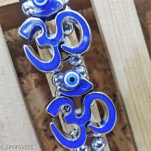 Clear glass charm with blue and silver om symbols, hangs from top
