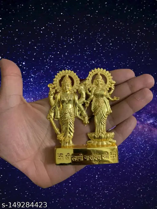 Golden idol of Laxmi and Narayan, about 10 cm tall, with a backdrop of a galaxy-themed background