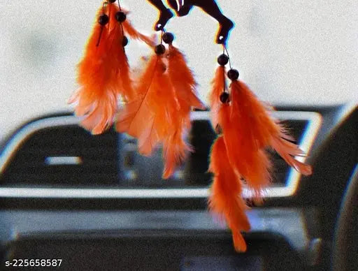 Handmade orange and black dream catcher for car decor, artfully woven by Indian artisans for a vibrant addition to your vehicle or home