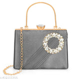 A designer evening handbag with a diamond frame, featuring a round embellishment and gold chain straps
